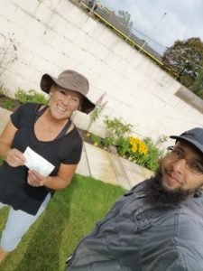 Amanda receiving a cheque from Imam Hassan